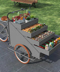 Slick Large Reverse Tricycle Vending Cart With Smooth Pedal Assist Front Loading Frame Four Tier Rollout Rack displaying snacks and beverages.