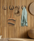 Heavy Duty Cast Iron Horseshoe Wall Hooks Wild West Coat And Hat Rack holding a jacket, hats, and a bag on wood wall.