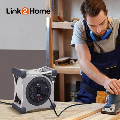 Built Tough Retractable Extension Cord Reel With Four Outlets And Circuit Breaker Protection 35 Foot Auto Rewind Design on workbench