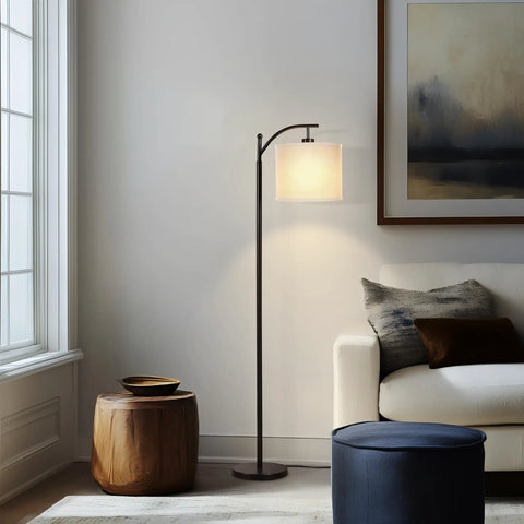 Arc Shaped LED Floor Lamp With Hanging Shade For Living Rooms And Offices Sleek Modern Lighting With Sturdy Marble Base Lit Reading Light Mid Century Farmhouse Style Black next to a couch.