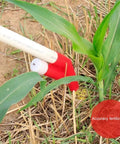 Manual Seed And Fertilizer Spreader With Comfortable Shoulder Strap And Ergonomic Handle For Farm Garden And Vegetables No Mess Easy To Use Bag Included Now in action, fertilizing corn plant.