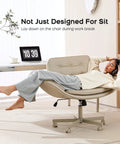 Person reclining on Criss Cross Office Chair With PU Leather Vanity Design, Ergonomic Comfort, cream color, at home office desk.