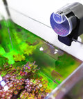 Slick Install Automatic Fish Feeder For Aquarium Battery Operated With Adjustable Portion Control And Vacation Timer mounted on tank.