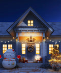Snowy house with Christmas lights and decorations on porch, snowman and tree, showcasing festive holiday atmosphere at night.