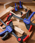 Go-To Mini Bar Clamp Set For Woodworking, Four-Piece One-Handed F Style Quick-Change Clamps on wooden workbench