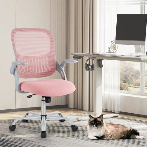 Ergonomic Mesh Office Chair For Home With Mid Back Support Rolling Swivel Desk Chair Lumbar Comfort Comfy Flip Up Arms Pink Ideal For Bedroom Study Student Use next to a desk with a cat on the floor.