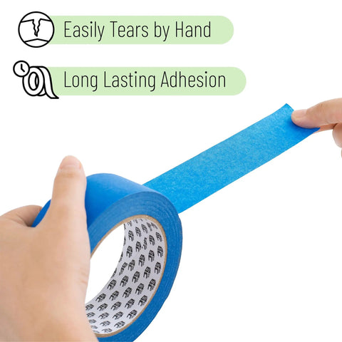 Hands tearing a roll of blue 0.7 Inch Painter's Tape 3 Pack With 54 Yards Each For Sharp Lines And Easy Removal
