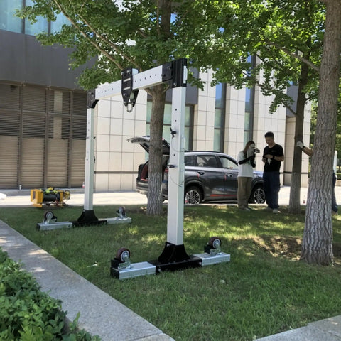 Heavy Duty Portable Gantry Crane Aluminum Frame with 360 Swivel Wheels set up outdoors, adjustable for height and width.