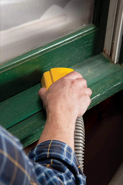 Lightweight Dust Free Sponge Sander Kit With Vacuum Hose And Two Sponges in use on green window frame