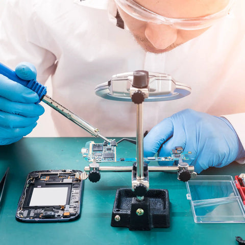 Technician using Lead Free Solder Wire With Rosin Core Flux 100g 0.5mm for electronics and PCB projects on a circuit board.
