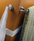 Preston Collection Chrome 24 Inch Bathroom Towel Bar Wall Mounted Towel Rack For Bath Or Kitchen, installed on an angled wall.