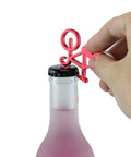 Hand using Compact Bike Bottle Opener Keychain Set Six Pack Lightweight Under Thirty Grams on a bottle.