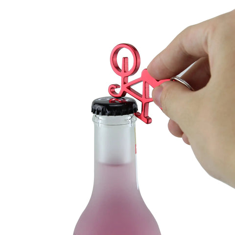 Hand using Compact Bike Bottle Opener Keychain Set Six Pack Lightweight Under Thirty Grams on a bottle.
