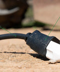 Hardcore 100 Foot Black Outdoor Extension Cord 10 Gauge 3 Conductor All Copper Wire Extra Heavy Duty Power Cable on dirt