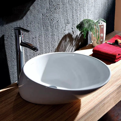 USZWBY Bathroom Vessel Sink Bathroom Vessel Sink Oval Above Counter White Porcelain Ceramic Bowl Basin, No Overflow Hole, Ceramic Sink Only Bathroom Sink on wooden countertop with chrome faucet.
