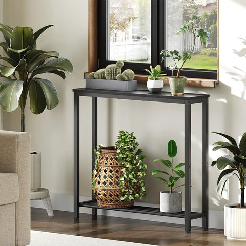 Slick Industrial Console Table For Tight Spaces, Hella Compact Two Tier Sofa Table With Open Storage Shelves, Matte Black Finish in a living room with plants.