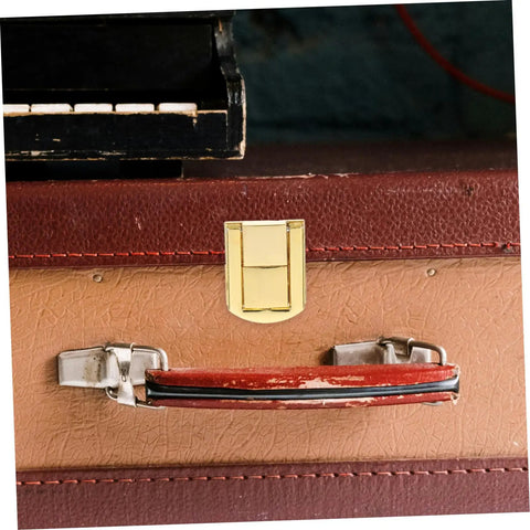 Close-up of retro style lock latch clasp kit for wooden boxes and jewelry cases secure closure hardware on vintage suitcase.