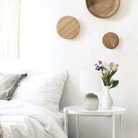 Geometric Concrete Table Lamp with White Fabric Drum Shade on nightstand, compact design, easy rotary switch, suitable for bedroom.