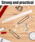 Uonlytech 50 Pack High Strength Safety Pins For Cardigans Shawls Heavy Duty Iron on a wooden table with sewing supplies.