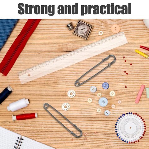 Uonlytech 50 Pack High Strength Safety Pins For Cardigans Shawls Heavy Duty Iron on a wooden table with sewing supplies.