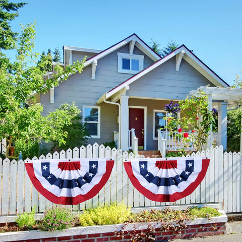 Patriotic Pleated Fan Flag Bunting Set With Brass Grommets And Zip Ties All American Flags For Outdoor Decor Perfect For 4th Of July Memorial Day One And A Half By Three Feet Four Pack Weatherproof And Easy To Hang On Fences Or Porches displayed on a white picket fence in front of house