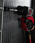 Air Impact Wrench One Half Inch Square Drive With Three Inch Extended Anvil For Lug Nuts And Bolts held against metal surface