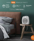 Dual Watt Personal Heater With 750 And 1500 Watts on wooden table in bedroom, fast warmth from fan forced heating