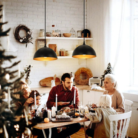 Two Pack Black And Gold Dome Farmhouse Pendant Lights For Kitchen Island And Dining Room illuminating a festive family gathering