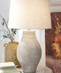 Dope Modern Table Lamp with Textured Paper Composite Base and Modified Drum Shade, 16 Inch, Beige Decor, on side table