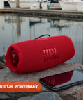 Charge 5 Portable Waterproof Bluetooth Speaker With USB Power Bank Output 20 Hours Play Time IP67 Beast Mode on rocks with phone