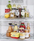 Lazy Susan Organizer For Refrigerator And Kitchen Turntable 14.56 Inch By 11 Inch Condiment Storage Fridge Organization Pantry Cabinet Countertop Organizer Grab And Go Rotating Shelf Requires Over 15.5 By 12 Inch Clearance showing condiments and bottles neatly arranged.