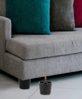 4 Pack Adjustable Furniture Levelers Screw On Feet for Cabinets And Tables 50mm Tall Plastic And Iron Legs in use under a sofa