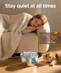 Stainless Steel Cat Water Fountain Two Point Six Liter Ultra Quiet Pet Fountain next to sleeping cat and person on sofa.