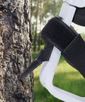 Close-up of Lightweight Aluminum Tree Climbing Spikes 1 Pair With Straps And Spike Protectors in use on tree.