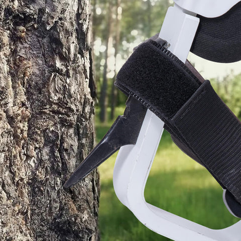 Close-up of Lightweight Aluminum Tree Climbing Spikes 1 Pair With Straps And Spike Protectors in use on tree.