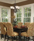 Rubbed Bronze Mini Chandelier With Warm Tea Stone Glass in a cozy transitional dining room over a rustic-modern table.