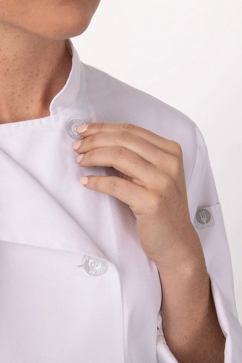 Close-up of a woman adjusting a double-breasted Le Mans Style Women’s Chef Coat With Side Seam Slits For Maximum Mobility