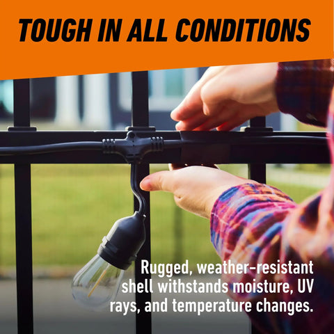 Person adjusting weather-resistant light bulb on an outdoor fixture, showcasing durability in various conditions.