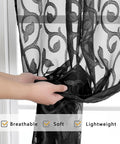 Close-up of Black Sheer Curtains 90 Inch Long Two Panel Set, light filtering semi sheer jacquard panels being held by hands.
