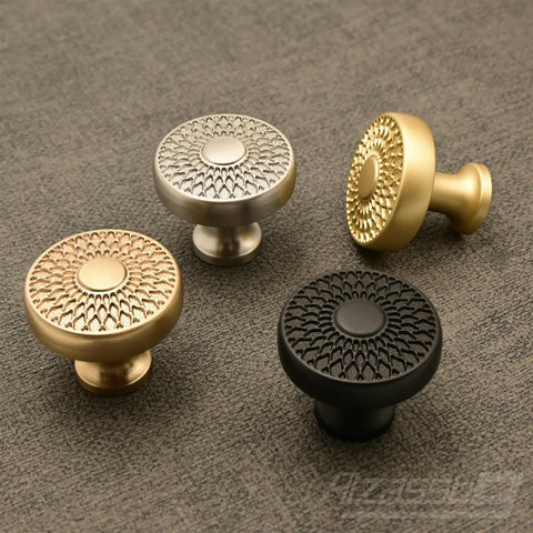 Four assorted filigree-patterned cabinet knobs including Champagne Bronze Round Cabinet Knobs One Point Four Inch Diameter.