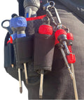 Ball Grip Bit Holder With Keychain For One Quarter Inch Hex Bits Handy Interchangeable Stubby Driver Red Cushioned Grip shown on tool belt.