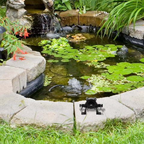 Compact Mini Self Priming Pump For Cordless Power Drills That Transfers Liquids Fast While Delivering A No Sweat Setup For Backyard Irrigation And Daily Home Tasks next to a pond with lily pads.