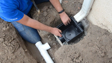 Installation of 12 Inch Square Catch Basin Drain With Two Openings into a landscape, connecting to drain pipes