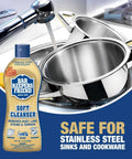 Soft Cleanser Liquid 2 Pack 13 Oz Bottles Multipurpose Cleaner and Rust Stain Remover for Stainless Steel Porcelain Ceramic Tile and More Tackle Grime Fast in Kitchen and Bath with stainless steel sink and cookware in background.