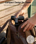 Person placing Mini Massage Gun With Heat For Deep Tissue Relief, Portable Percussion Massager into a brown bag for travel use