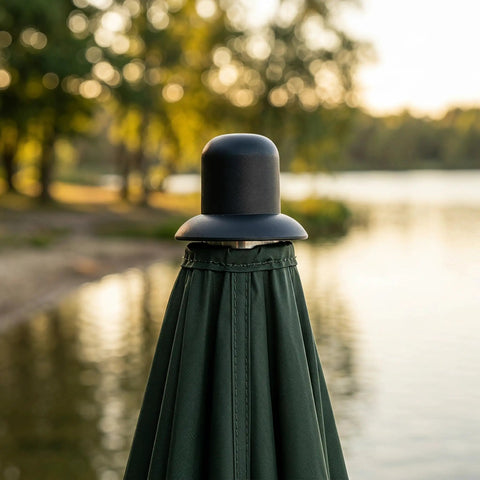 Upgrade Your Outdoor Space with These Durable Black Plastic Beach Umbrella End Caps Featuring Threaded Spiral Finial Design, Universal 24 Type Patio Umbrella Repair Kit Built Tough For Rain Resistant Performance In Any Backyard Or Garden Setting Perfect. Black plastic umbrella end cap on folded patio umbrella by water