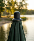 Heavy Duty Black Plastic Umbrella End Caps With Threaded Spiral Finials Perfect For Patio Repair And Keeping Outdoor Gear Looking Fresh Ready For Backyard Fun Or Beach Vibes During Summer Months, black umbrella top cap over folded canopy by water