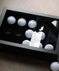 15 Ball Golf Ball Display Case Wooden Shadow Box With Acrylic UV Dust Cover on table, angled view, black interior, showcasing golf balls.