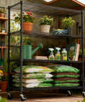 Heavy Duty 4 Tier Metal Storage Shelving Unit With Wheels For Garage Pantry Kitchen Basement Black, 1400 Lbs Total Capacity, 47.2 Inches Wide, 62.7 Inches High, 17.7 Inches Deep, Adjustable Wire Shelves, with potted plants and garden supplies