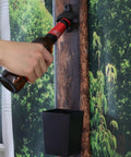 Heavy Duty Cast Iron Bottle Cap Opener Wall Mounted With Catcher Tray For Garage Bar Or Home Man Cave in use, bottle being opened.